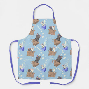 Cats in box and milk drops on blue apron