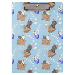 Cats in box and milk drops on blue clipboard