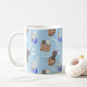 Cats in box and milk drops on blue coffee mug