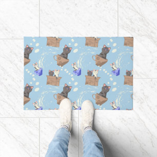 Cats in box and milk drops on blue doormat