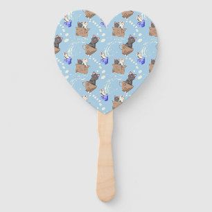 Cats in box and milk drops on blue hand fan