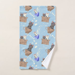 Cats in box and milk drops on blue hand towel