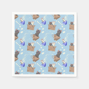 Cats in box and milk drops on blue napkin