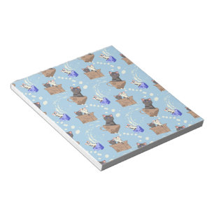 Cats in box and milk drops on blue notepad