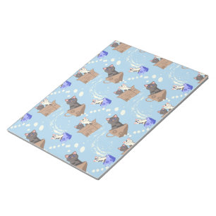 Cats in box and milk drops on blue notepad
