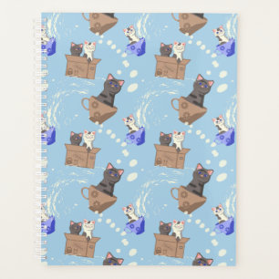 Cats in box and milk drops on blue planner
