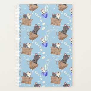 Cats in box and milk drops on blue planner