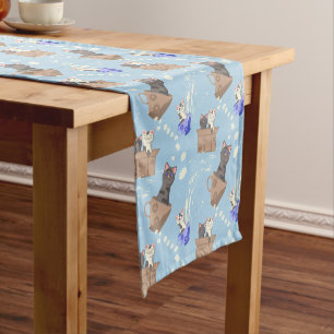 Cats in box and milk drops on blue short table runner