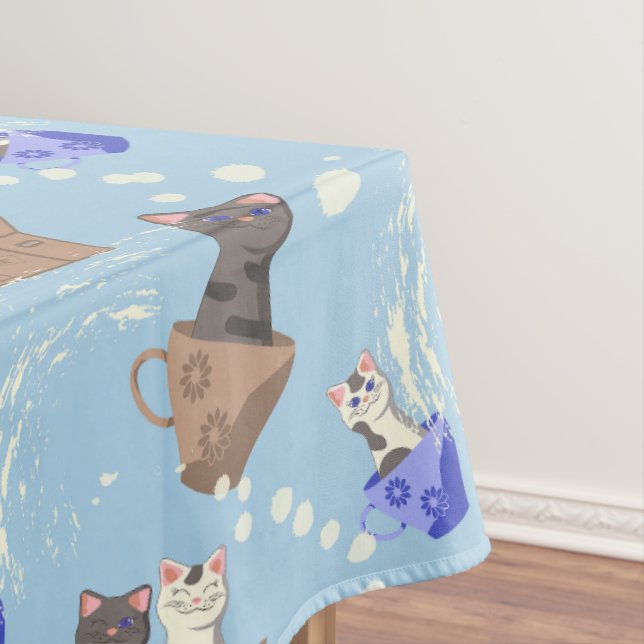 Cats in box and milk drops on blue tablecloth (In Situ)