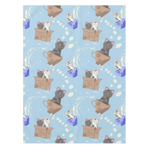 Cats in box and milk drops on blue tablecloth