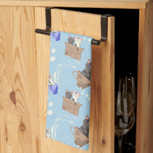 Cats in box and milk drops on blue tea towel