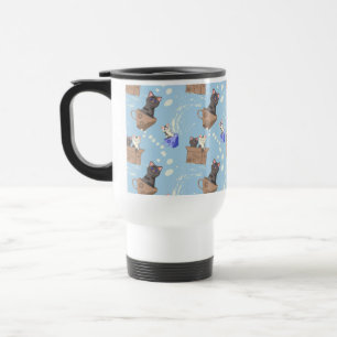 Cats in box and milk drops on blue travel mug