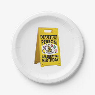 Caution person celebrating brithy with yellow sign paper plate