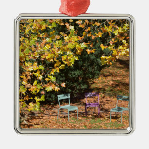 Chairs among fall leaves metal tree decoration