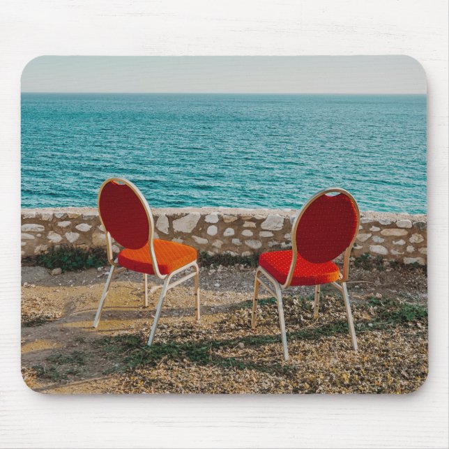 Chairs on coast of ocean under sky mouse mat (Front)