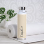Champagne Colour Personalised Wedding Bridesmaid Water Bottle<br><div class="desc">Gift your wedding bridesmaid or maid of honour with this trendy, vacuum Insulated water bottle that features her name in grey, stylised script on a champagne colour background designed to match your wedding colour scheme. Personalise bottle by editing and replacing name with your own as desired. Select your water bottle...</div>