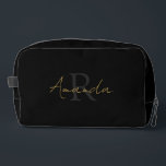 Chic Black Gold Monogram Dopp Kit<br><div class="desc">Indulge in a little bit of luxury with our chic black and faux gold toiletry bag perfect for the modern sophisticated woman. Both sides show your initial and first name. The initial is of a lighter black for a great visual effect and your first name sits on top in faux...</div>