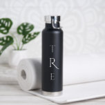 Chic Monogram on Black Water Bottle<br><div class="desc">Chic white vertical monogram on black features a larger more decorative initial in the centre. Replace the 3 initials with your own in the sidebar.

Other water bottle colours and styles available in the sidebar.

Copyright © Claire E. Skinner. All rights reserved.</div>