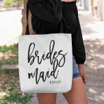 Chic Script Personalised Bridesmaid Tote Bag<br><div class="desc">Gift your bridesmaids with these super cute personalised tote bags! Trendy and modern black and white design features "bridesmaid in black handwritten script typography. Easily customise with your bridesmaid's name using the template field provided.</div>