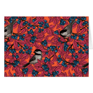 Chickadee birds on blueberry branches on orange