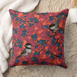 Chickadee birds on blueberry branches on orange cushion