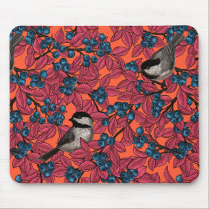 Chickadee birds on blueberry branches on orange mouse mat