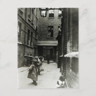 Children playing in a slum, 1899 postcard