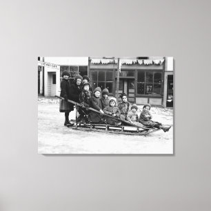 Children Playing on Sleigh in Seward Canvas Print