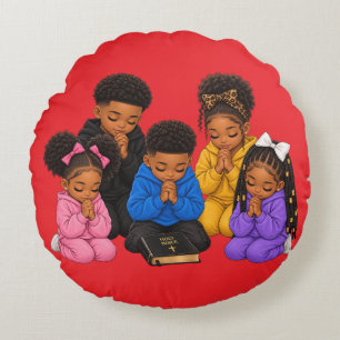 Children praying round cushion