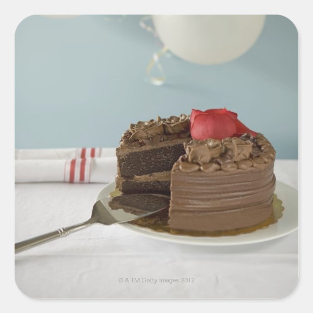Chocolate cake with missing slice on table, square sticker (Front)