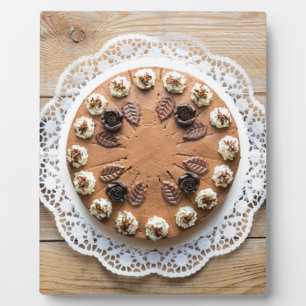 Chocolate cream pie on rustic wood cake top plaque