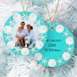 Christmas Beach Wreath Sand Dollar Starfish Ceramic Tree Decoration<br><div class="desc">A wreath of white sand dollars, starfish, and aqua glitter coral frame the family photo on the front of this beach themed ornament, with an aqua blue background, with family name, year, and Merry Christmas on the back. Please contact me through Zazzle Chat if you need matching products, design tweaks...</div>