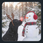 Christmas Black Labrador Retriever with Snowman Square Sticker<br><div class="desc">A black Labrador retriever with a glowing red nose and reindeer antlers stands beside a snowman in a winter forest</div>