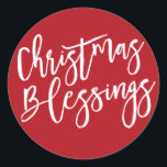 Christmas Blessings, Modern Handwritten Typography Classic Round Sticker<br><div class="desc">Christmas Blessings is written in a bold white very trendy and modern script. It really shows up on a deep holiday red background. Attach this Christmas sticker anywhere you want to emphasise the true meaning of Christmas. Use it to seal your Christmas card envelopes or to add a special touch...</div>
