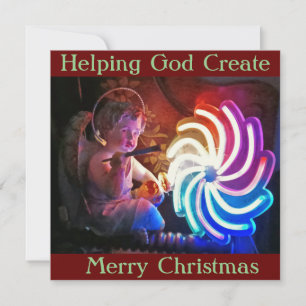 Christmas Card shows Cherub "helping God Create"