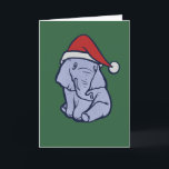 Christmas Elephant Card<br><div class="desc">A small, soft-hued elephant sits calmly against a deep green backdrop, wearing a simple red winter hat that shifts the mood from ordinary wildlife to quiet seasonal charm. Its relaxed posture and subtle linework make the character approachable without slipping into overly cute territory. This design works well for winter celebrations,...</div>
