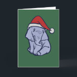 Christmas Elephant Card<br><div class="desc">A small, soft-hued elephant sits calmly against a deep green backdrop, wearing a simple red winter hat that shifts the mood from ordinary wildlife to quiet seasonal charm. Its relaxed posture and subtle linework make the character approachable without slipping into overly cute territory. This design works well for winter celebrations,...</div>