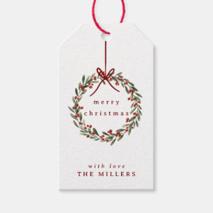 Christmas foliage wreath with red bow on white gift tags
