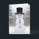 Christmas Happy Snowman Wearing a Top Hat Card<br><div class="desc">A cheerful snowman in a snowy landscape wears a stylish black top hat and has a bright carrot nose.
Inside text can be changed.</div>