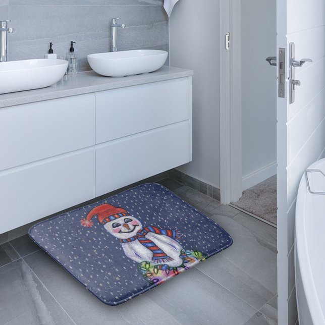 Christmas Lights Smiling Snowman Snowflakes Bath Mat (Snowman red blue hat scarf holding glowing Christmas lights in snow on dark blue bath mat.)