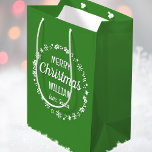 Christmas Love Santa Personalised Name Green Medium Gift Bag<br><div class="desc">Create your own 'Love,  Santa' gift bag with this fun and festive design! A stylish template,  personalised with the recipient's name and featuring an illustrated border with snowflakes,  holly,  Christmas stockings and stars. An unique way of presenting a gift to someone special! Colours: green and white.</div>