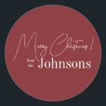 Christmas Modern Family Name Maroon Classic Round Sticker<br><div class="desc">This is a modern, Merry Christmas design. It is in trending maroon / burgundy and has the message, "Merry Christmas! from the Johnsons". Ideal for your Christmas gift wrap, mailing accessories. envelope seals, and party favour seals this festive season. To personalise, simply add your name in the personalise this text...</div>