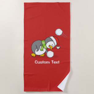 Christmas penguin getting a snow ball beach towel