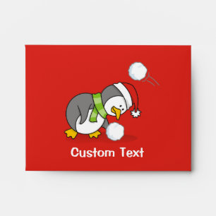 Christmas penguin getting a snow ball envelopes