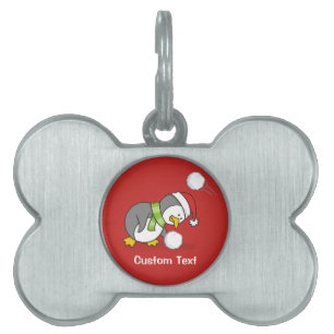Christmas penguin getting a snow ball pet ID tag