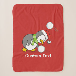 Christmas penguin getting a snow ball sherpa blanket