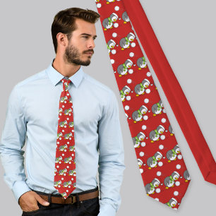 Christmas penguin getting a snow ball tie