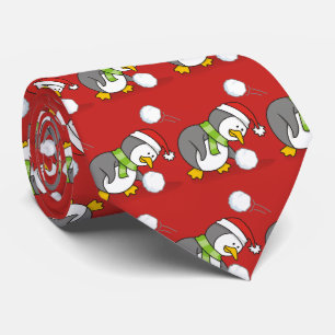 Christmas penguin getting a snow ball tie