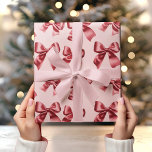 Christmas Red Bow on Pink Background  Wrapping Paper<br><div class="desc">Wrap your gifts in festive style with this Christmas Red Bow on Pink Background Wrapping Paper. The elegant red bows pop against the soft pastel pink background, creating a playful and chic holiday look. Perfect for adding a modern twist to your Christmas presents, this wrapping paper is ideal for those...</div>