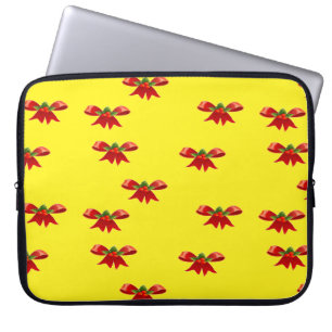 Christmas red ribbon on yellow laptop sleeve